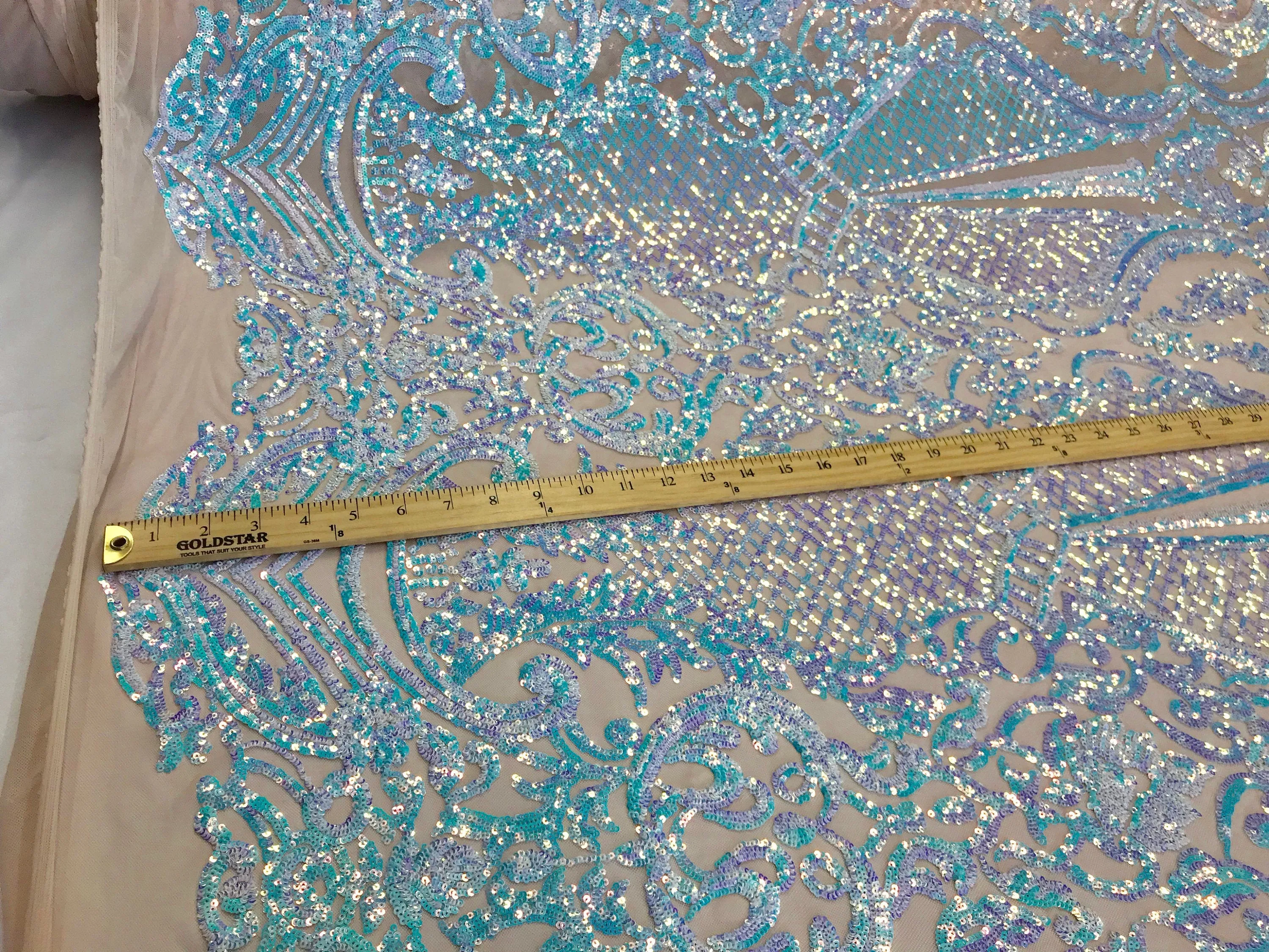 Aqua princess design iridescent sequins embroidery on a 4 way stretch nude mesh-sold by the yard.