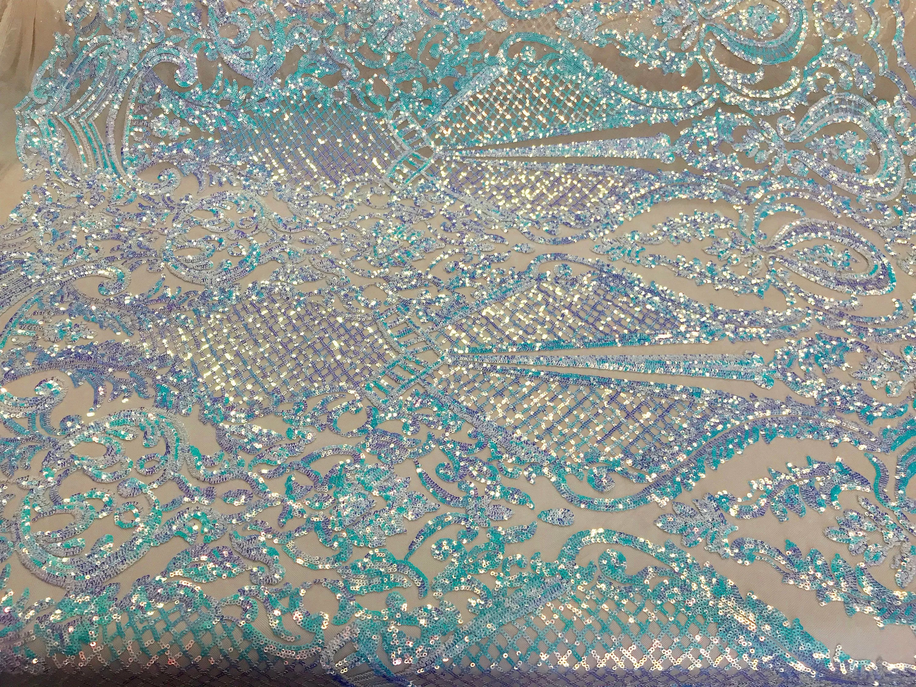 Aqua princess design iridescent sequins embroidery on a 4 way stretch nude mesh-sold by the yard.